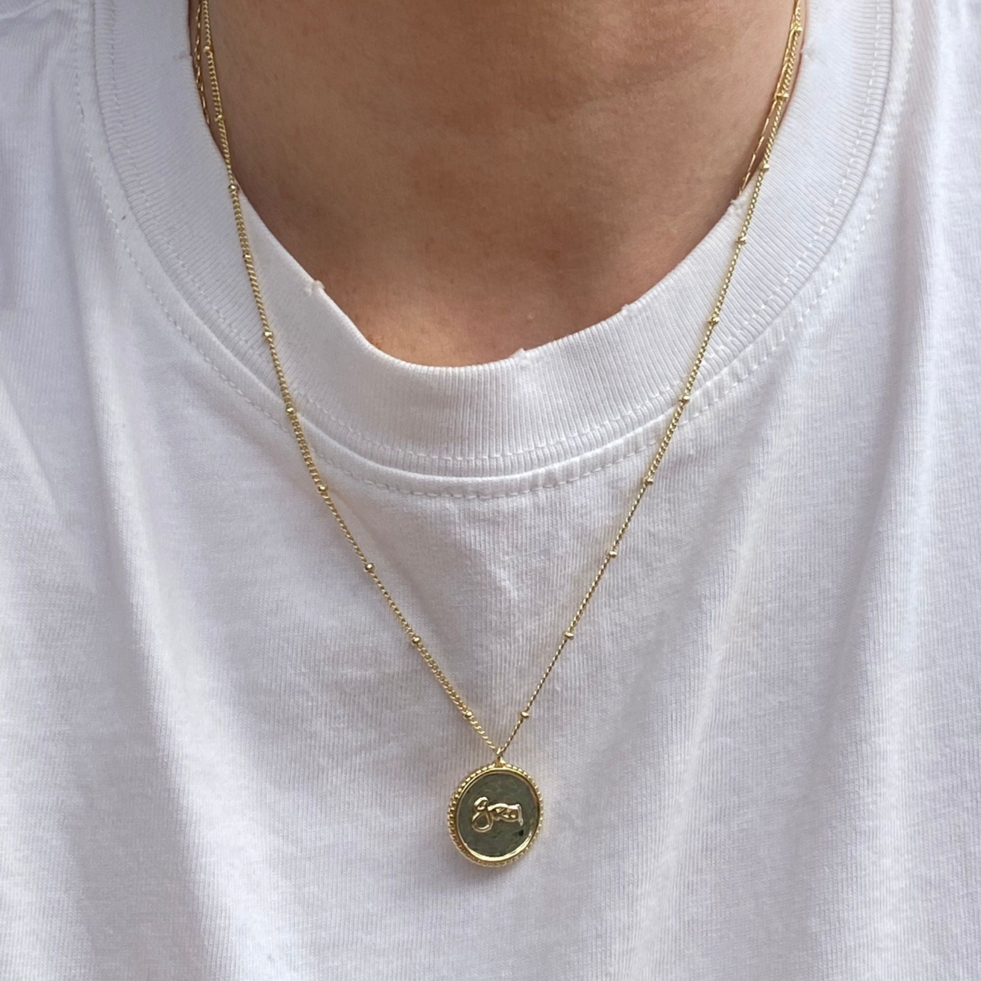 Model wearing Grá Medallion Gold Necklace